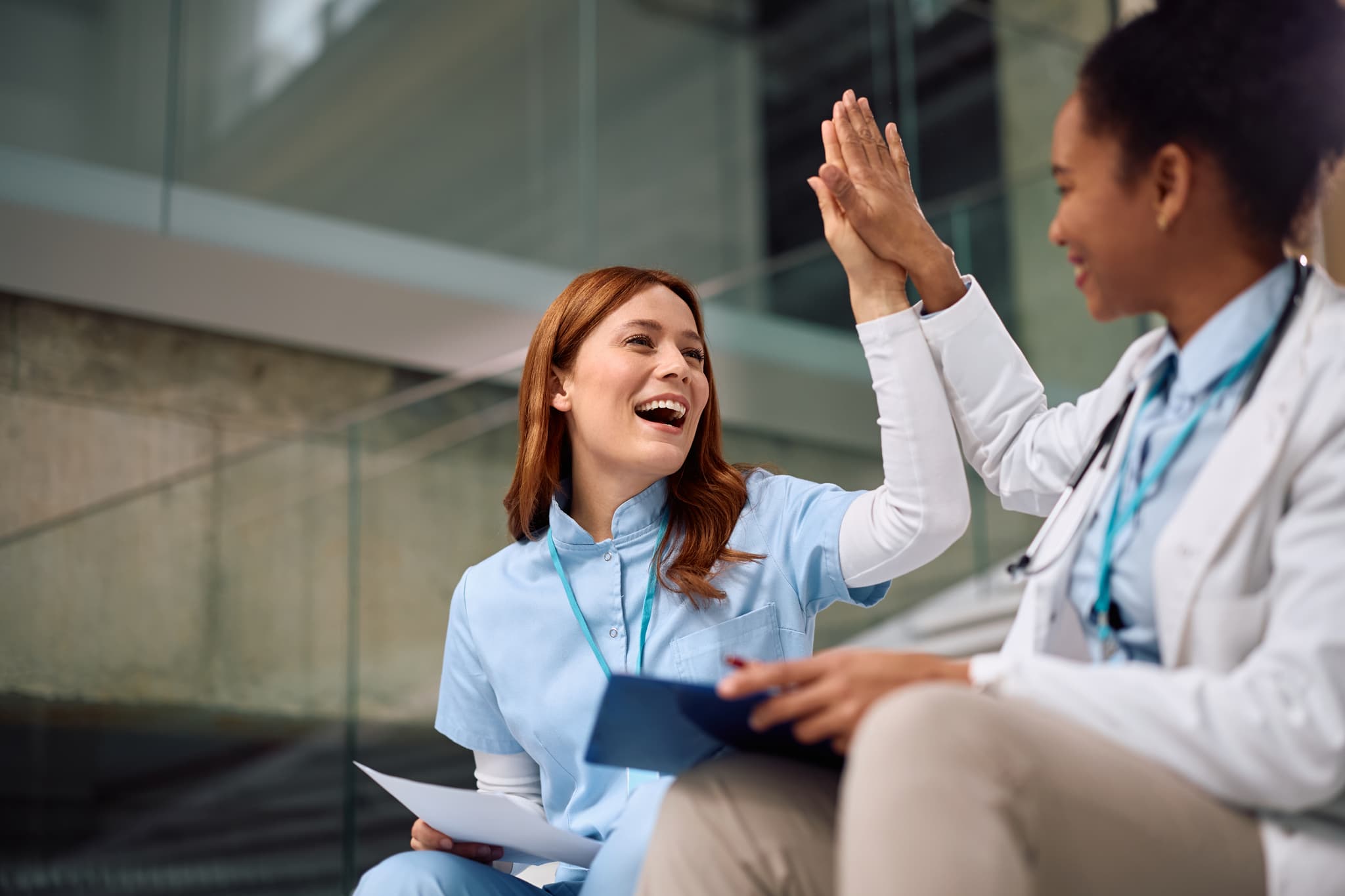 Psychiatric Mental Health Review - clinicians celebrating with a high five while working, PMHNP-BC exam preparation