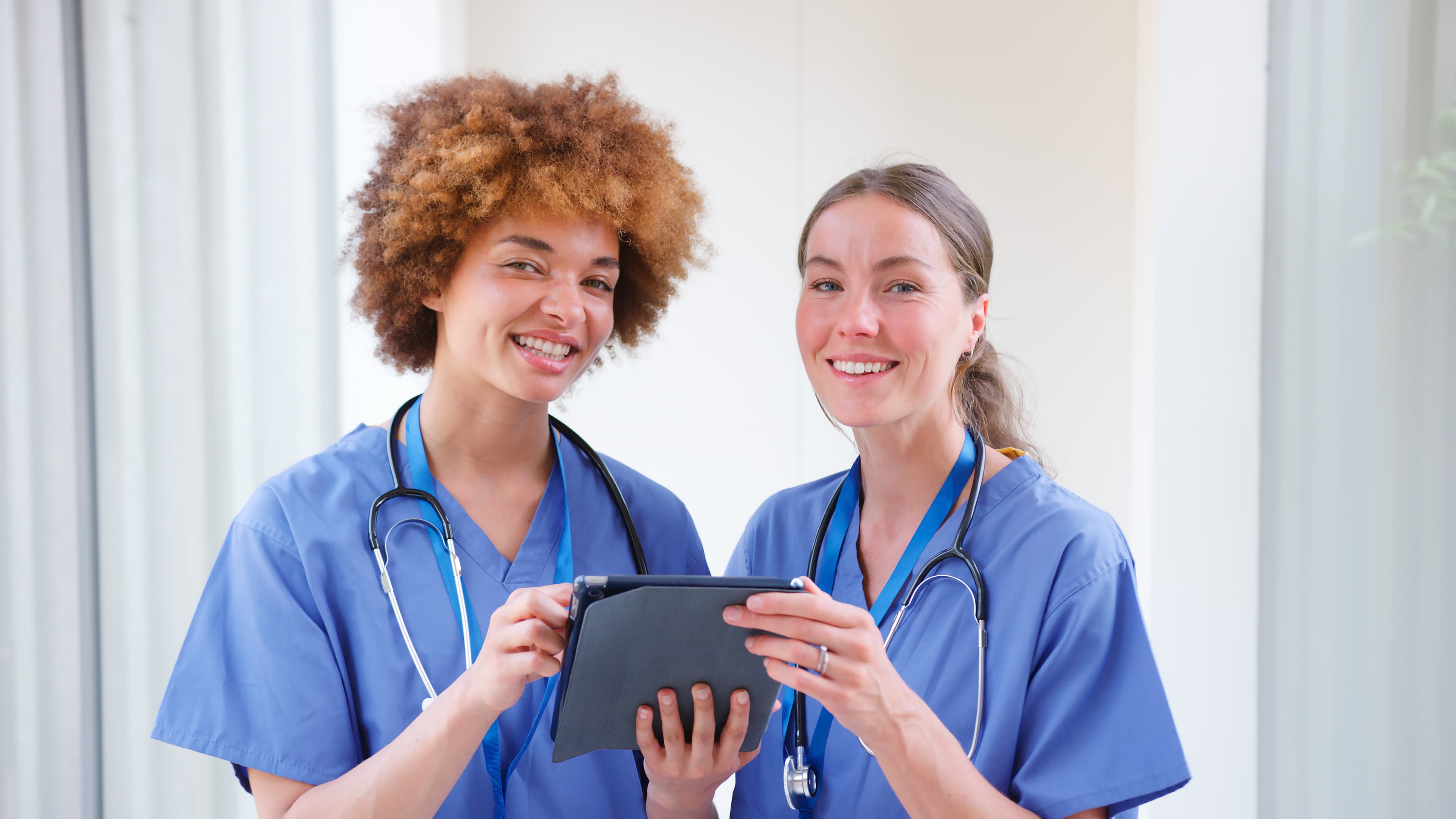 PMHNP-BC™ – Psychiatric Mental Health Nurse Practitioner – Board Certified PMHNP-BC (Psychiatric Mental Health Nurse Practitioner – Board Certified) exam information - nurse practitioners with a digital tablet in a clinical setting | Psychiatric Mental Health Review
