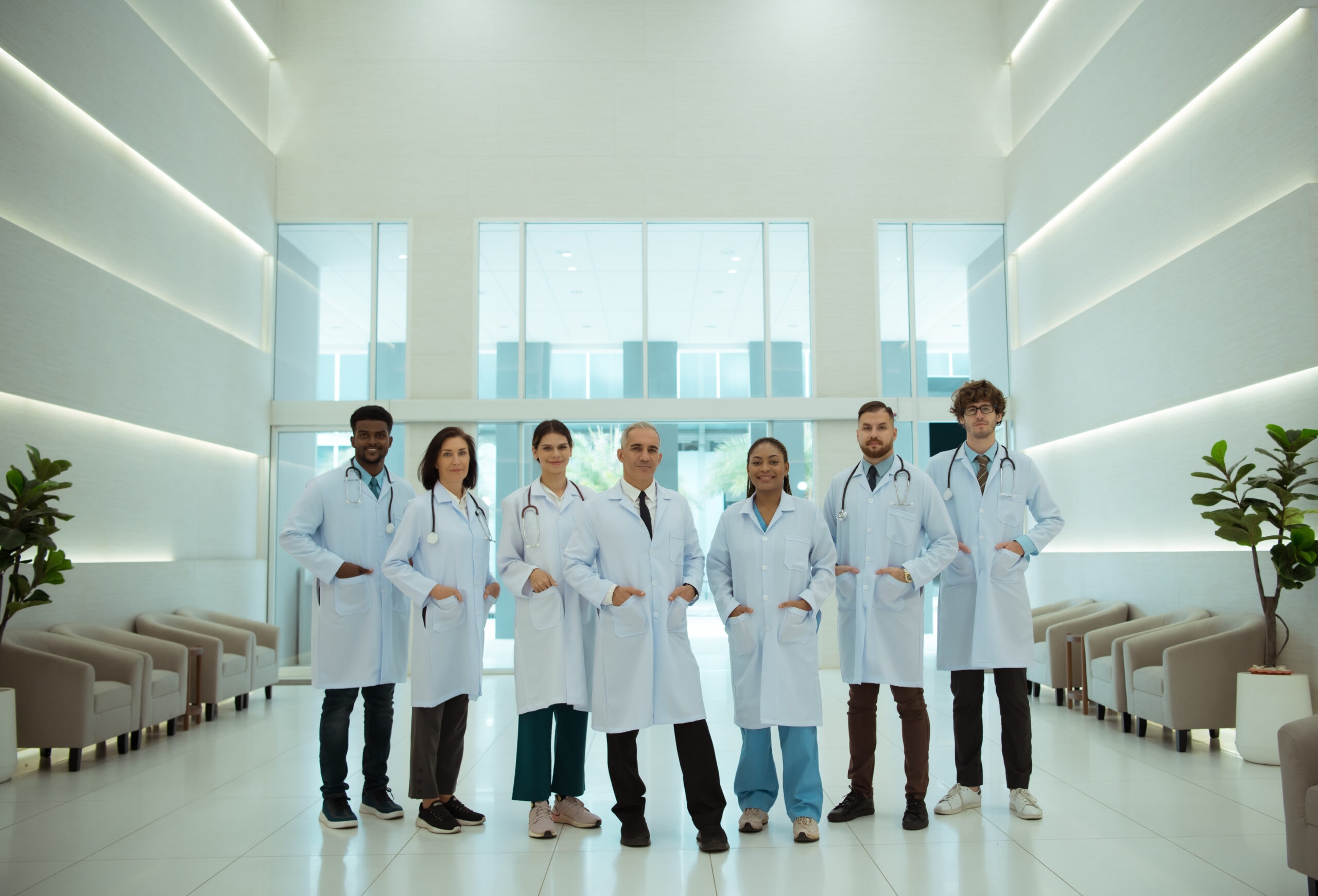 About Us – PMH-BC Review Course Psychiatric Mental Health Review - a diverse group of medical professionals in white lab coats standing in a modern hospital lobby